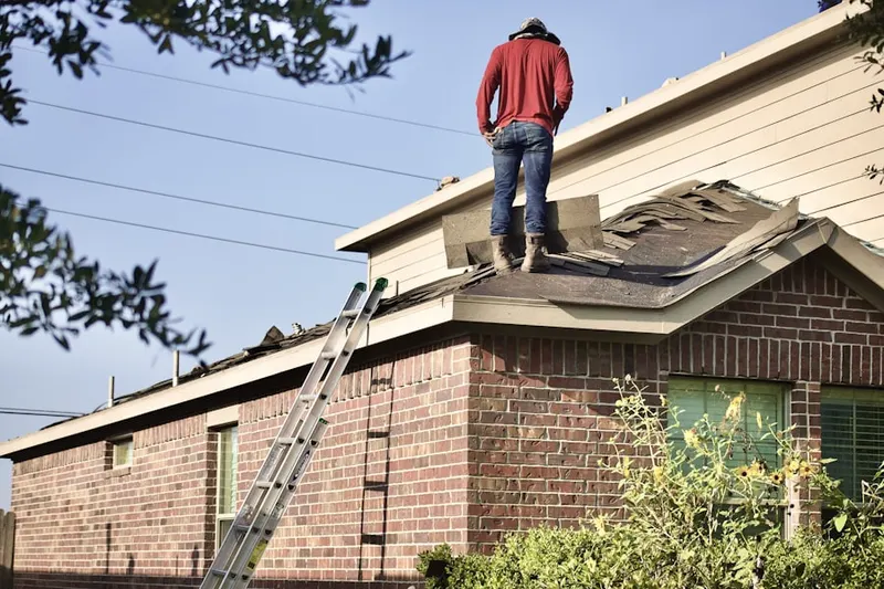 Professional roofer working on a residential roof in Philipsburg
